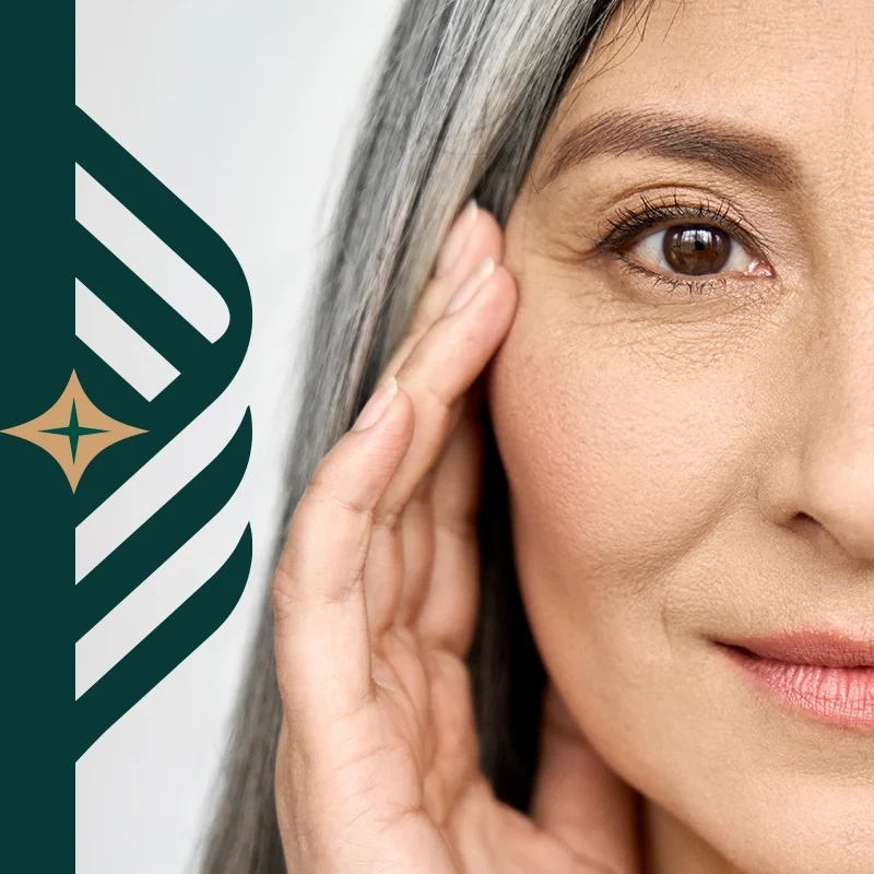 A woman with long gray hair resting her hand against her cheek