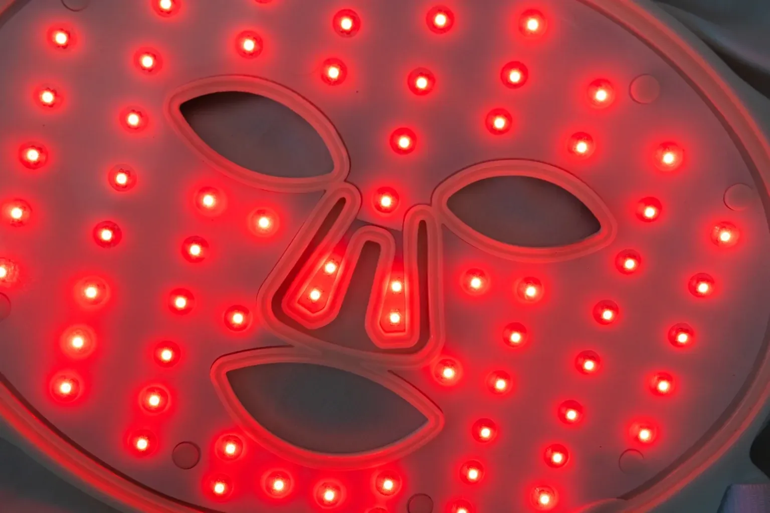 The Fotoage light therapy mask glowing red